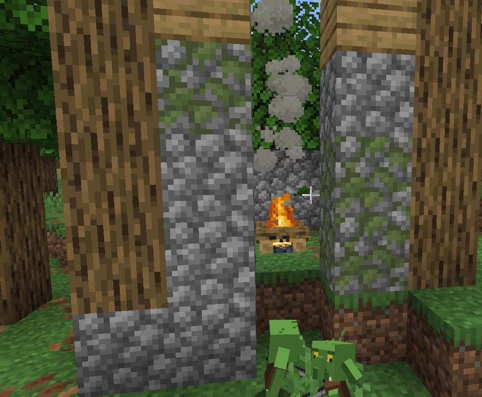A goblin camp under construction: cobblestone and oak walls around a central campfire, with goblins nearby