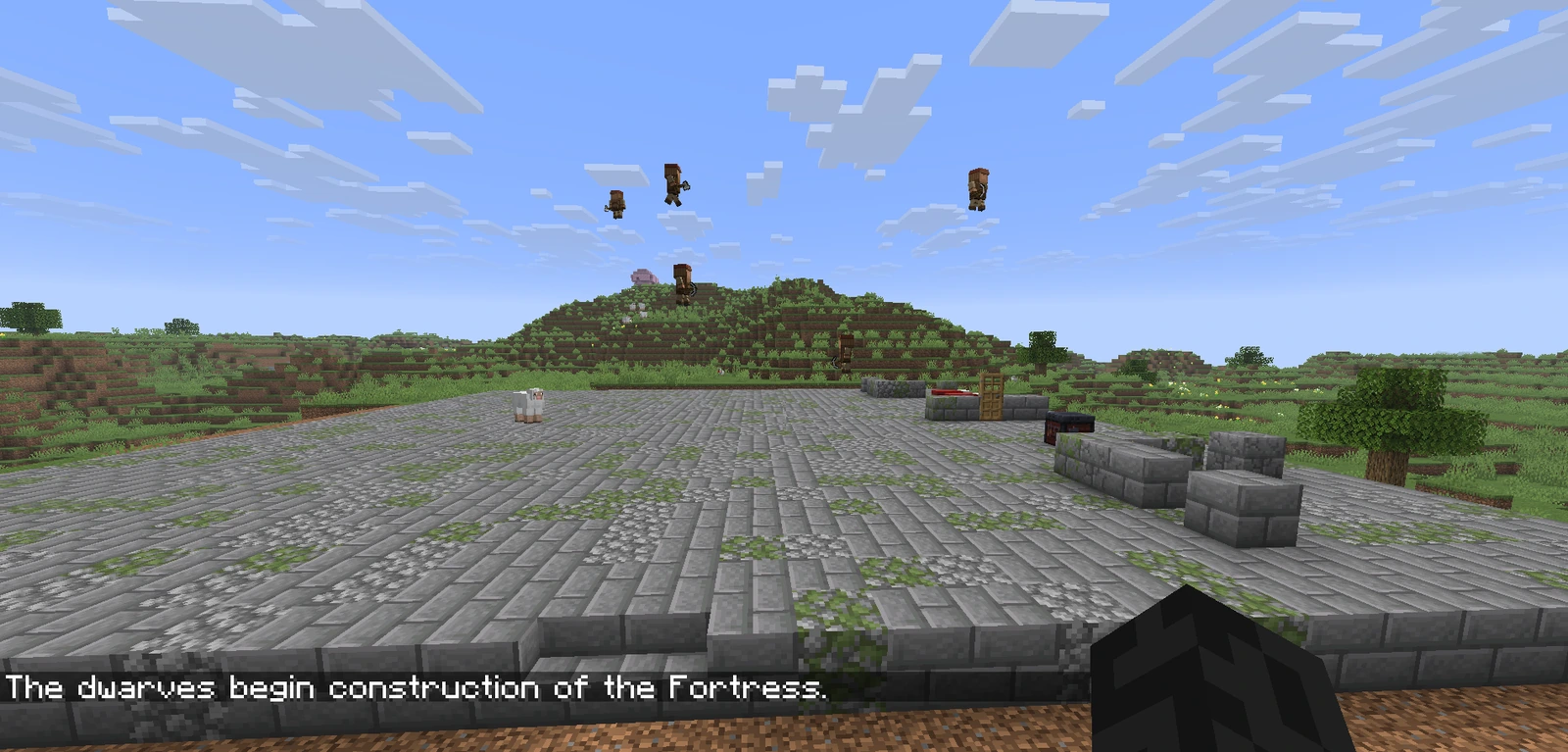 Dwarves at work on a large stone foundation, with the message: The dwarves begin construction of the Fortress