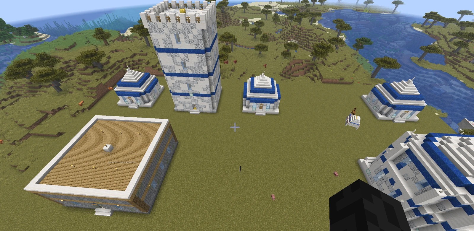 An elven town of white and blue quartz buildings on cleared flat ground, with a tall guard tower at its centre