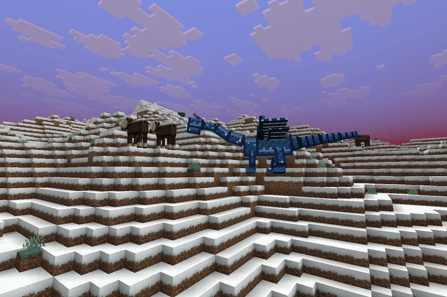 A blue dragon standing on snowy hills beside two dark horses